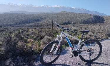 An ebike with the White Mountains of Chania in the background