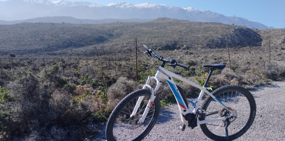An ebike with the White Mountains of Chania in the background